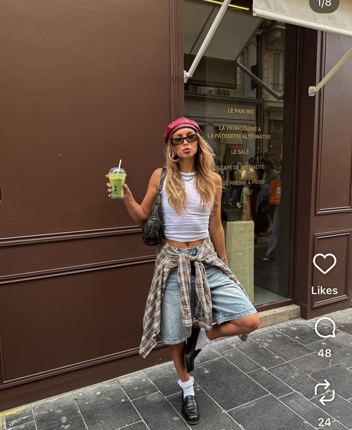 A screenshot of a social post showing a street style outfit, with a carousel counter and a like and share rail overlaid on the photo